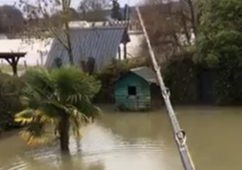 French Fisherman Casts Line From Balcony Into Seine Floodwaters