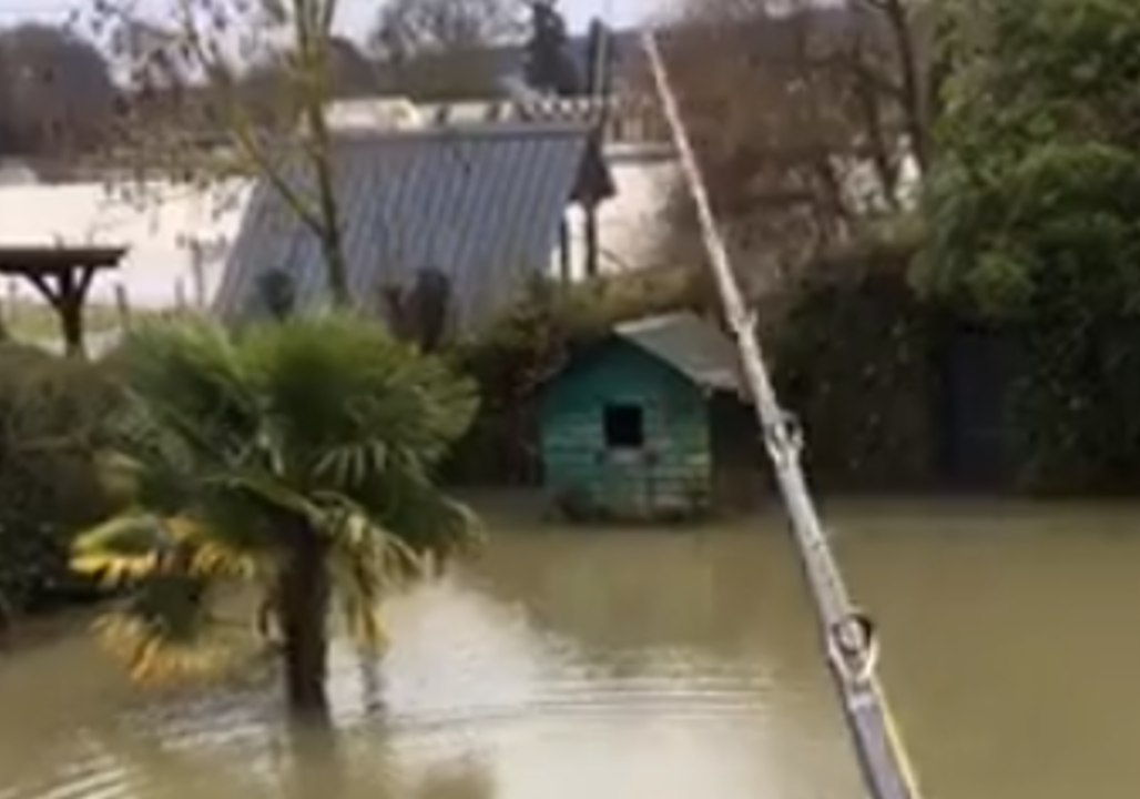 French Fisherman Casts Line From Balcony Into Seine Floodwaters