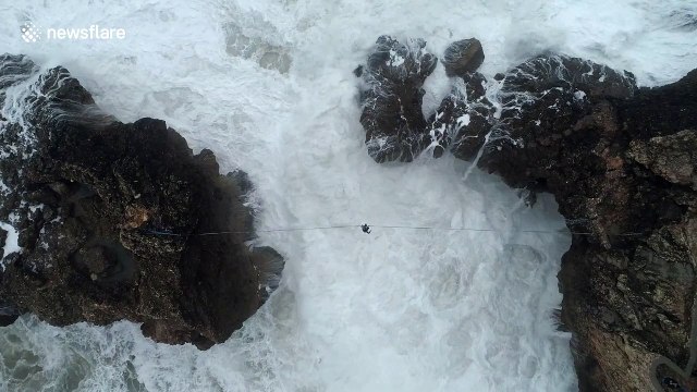 Amazing drone video shows daredevil slacklining above giant waves in Portugal