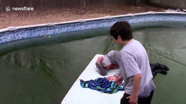 Dad in hilarious frozen pool cannonball fail