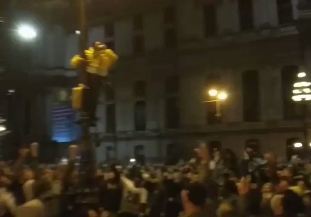 Eagles Fans Climb Lampposts as They Celebrate Super Bowl Victory in Philadelphia