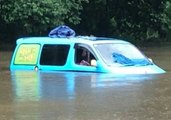 British Backpackers Wake Up to Find Van Partially Submerged by Floodwaters