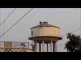 Man climbs on the water tank in Rampur