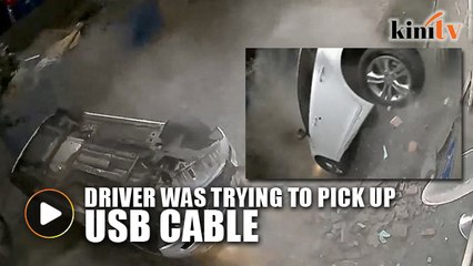 Car driven through second floor parking lot wall