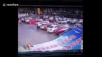 Giant billboard collapses on top of woman carrying child