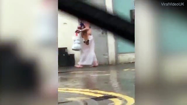Semi-naked man wearing bikini and shower curtain skirt in Cardiff