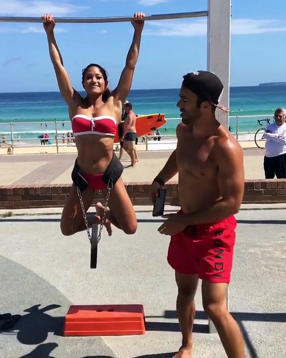 Woman Does Weighted Pull-Ups at Beach