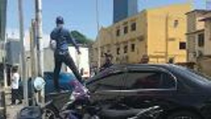 Unhappy with DBKL's car clamping, man protests on a car