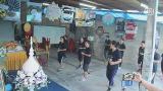 Friends dance aerobics at funeral