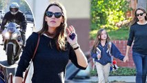 That's her girl! Doting mother Jennifer Garner holds daughter Seraphina's hand... as Ben Affleck makes his way across town by motorcycle.