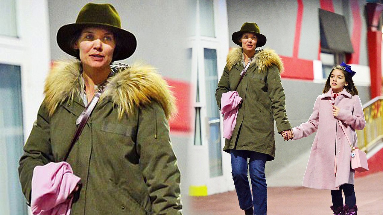 Girl time! Doting mom Katie Holmes holds hands with daughter Suri Cruise as they bundle up for dinner in New York City.