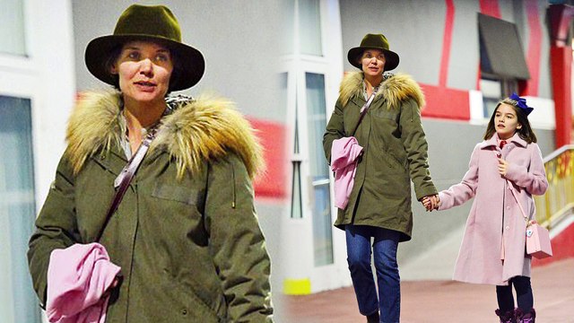 Girl time! Doting mom Katie Holmes holds hands with daughter Suri Cruise as they bundle up for dinner in New York City.