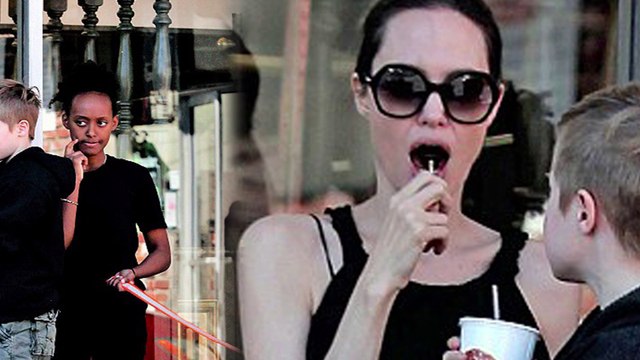 Sweet treat! Angelina Jolie enjoys a lollipop while collecting takeaway pizza with daughters Shiloh and Zahara.