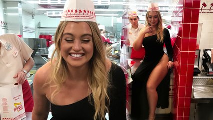 Underwear free Iskra Lawrence has a very cheeky response after being told off for sitting on the counter in fast food eatery in THAT sexy thigh-split dress.