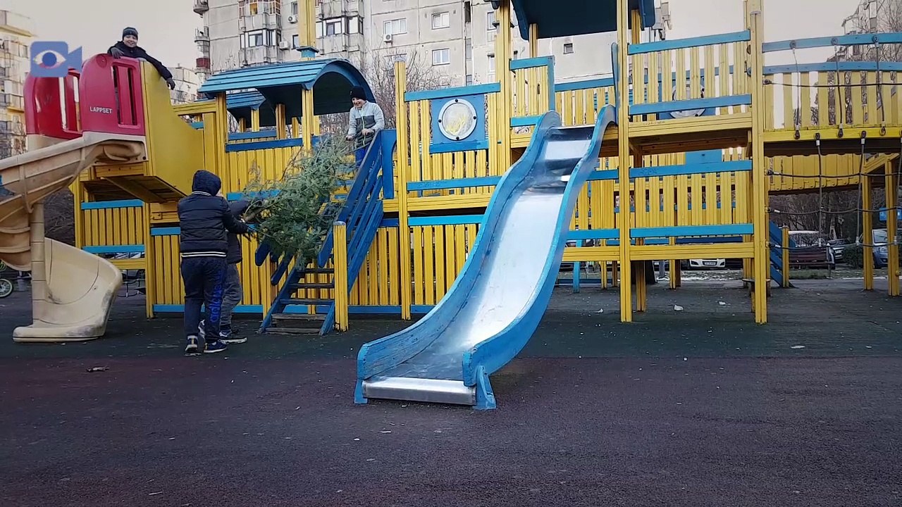Outdoor playground, kids playing with a Christmas Tree