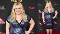All that glitters! Rebel Wilson dazzles in shimmering wrap dress on the red carpet of the G'Day USA event in Los Angeles.