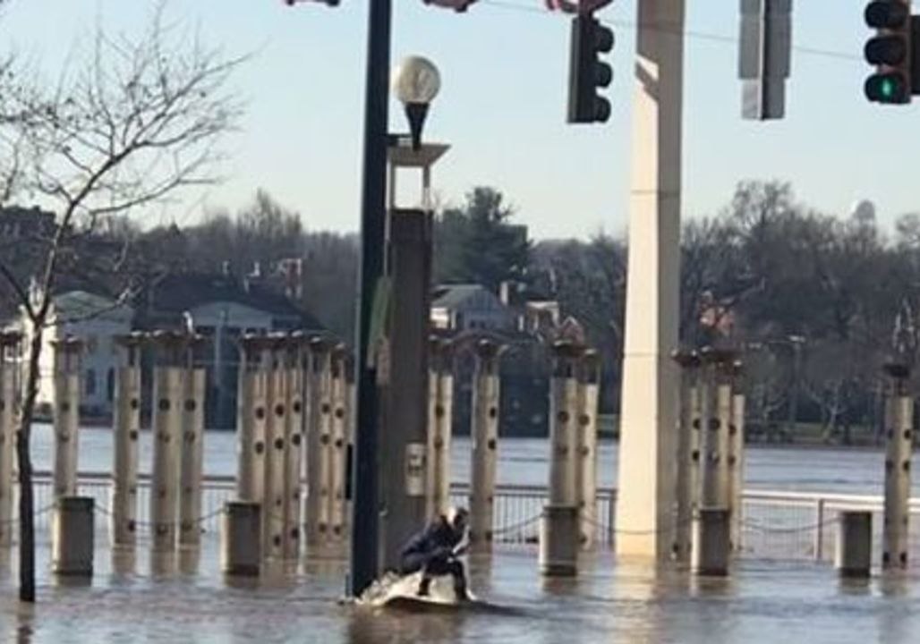 Boarder Skims Across Cincinnati Floodwater