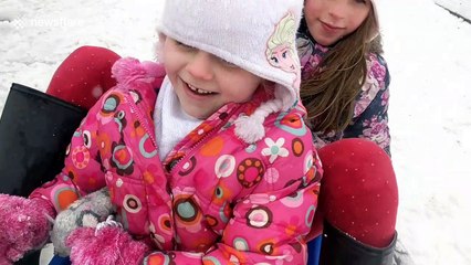 Sisters sledge as snow arrives in Kent