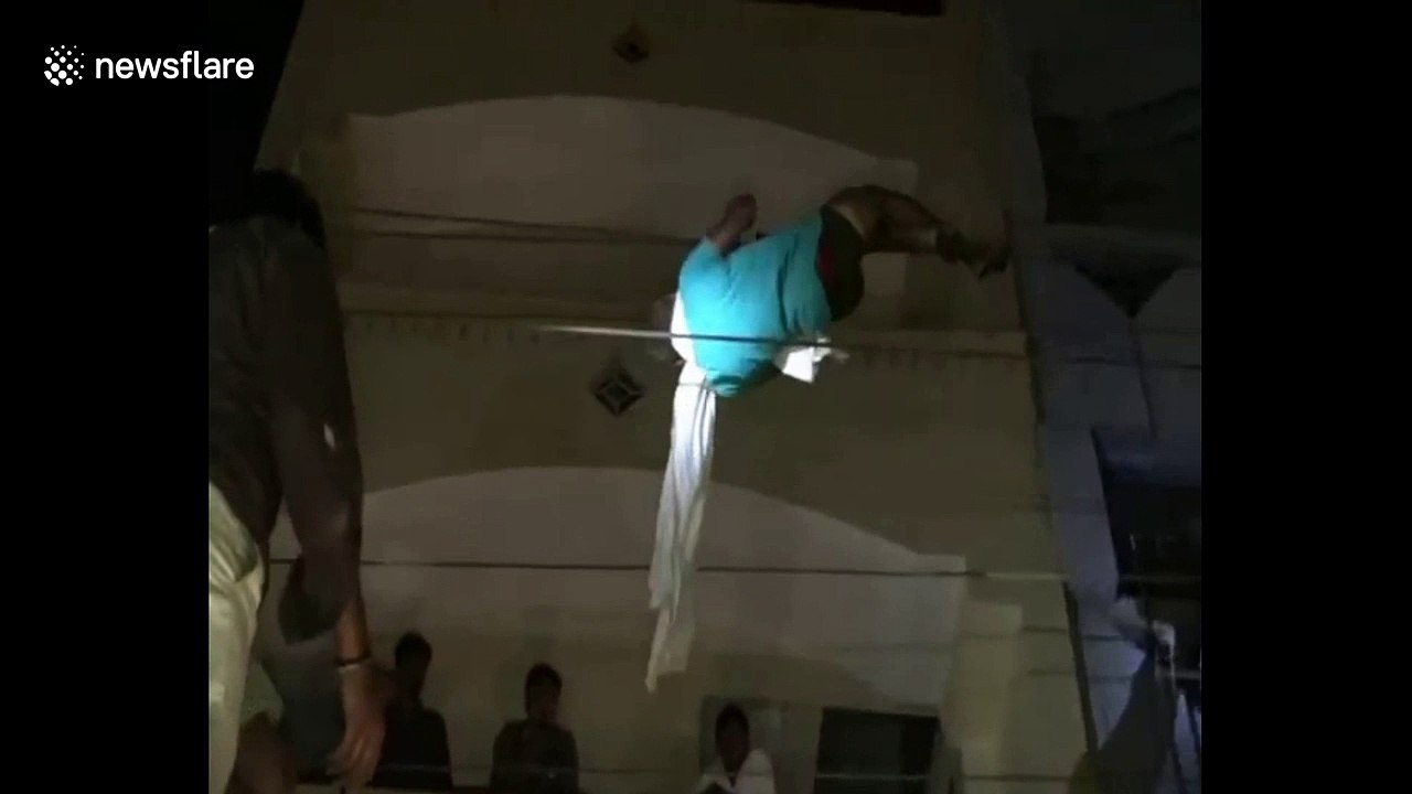 Man rescued after he dangles dangerously from overhead power lines