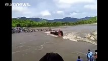 Passengers escape through windows as bus overturns in swollen river, Peru