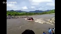 Watch: Passengers trapped after bus overturns into swollen river in Peru