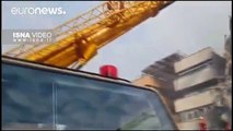Tehran building collapse: search for dozens of missing firefighters