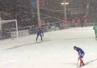 Fans Cheer Peterborough United Player Shovelling Snow During Match
