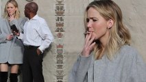 Let's blow this joint! Jennifer Lawrence rocks thigh high boots as she smokes hand rolled cigarette in alley with mystery man before leaving lunch spot