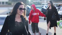 Angelina Jolie turns heads in a black lace dress as daughter Shiloh, 11, shows her support for Liverpool FC in red hoodie after European trip.