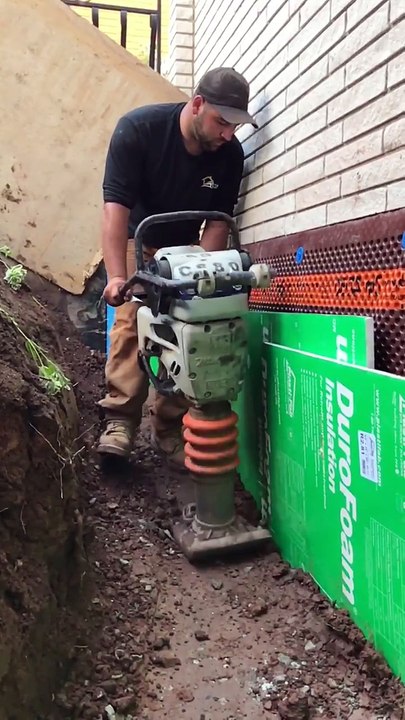 Packing backfill at a waterproofing project.