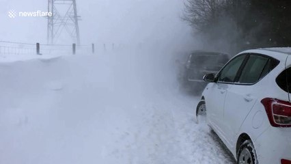 Giant snow drifts bring Greater Manchester roads to a standstill