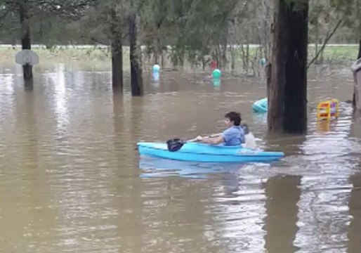 Man Kayaks on a Flooded Front Yard in Lewisburg, Tennessee