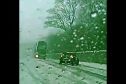 by inches This is the terrifying moment a bus narrowly avoids crashing into an out-of-control on an icy road.