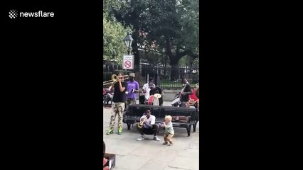 Watch this adorable toddler jam with a New Orleans brass band
