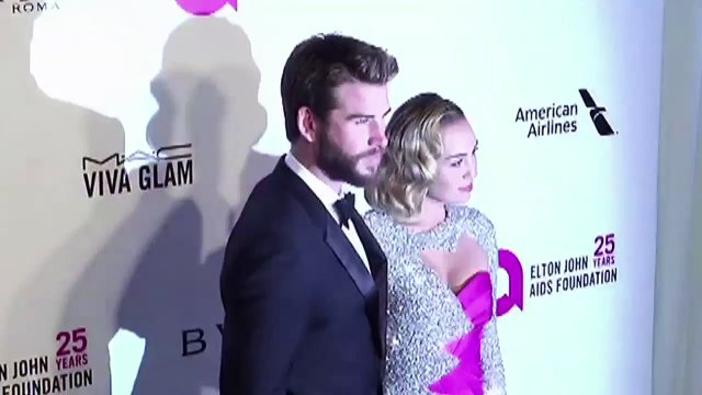 Miley Cyrus & Liam Hemsworth Get Cosy At Elton John Oscars After Party