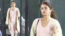 Pretty in pale pink! Makeup-free Selena Gomez models baggy clothes as she leaves church in Los Angeles on Sunday without beau Justin Bieber.