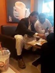 Imran Khan eating something dipping it into a cup of coffee
