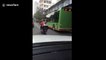 Chinese student completes homework riding on back of scooter