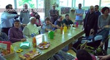 The Pope visits a center for the mentally disabled and shares a snack with them