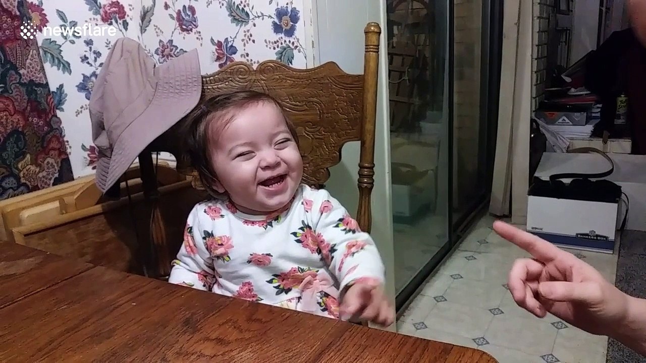 Hilarious moment when baby girl realizes dad is filming