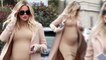 She's got that glow! Pregnant Khloe Kardashian flaunts her baby bump in skintight dress and duster coat for baby clothes shopping with mom Kris Jenner.