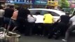 Crowd lifts car to save elder trapped underneath