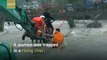Firefighters use excavator to save woman trapped in east China river