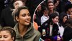 Kim Kardashian cuddles daughter North as she joins giggling Kendall, Kourtney and Penelope on family trip to basketball game.