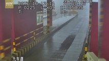 Semi-trailer slides off slippery road, smashes into toll booth