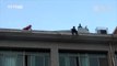 Footage: Firefighter dashes to stop man jumping off building