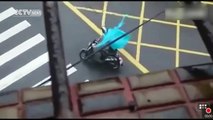 Footage: Man on electric bike blown away by Typhoon Sarika