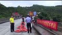 Woman rescued from raging river as flash floods strike Guangxi