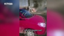 Footage:  Passengers trapped in burning car