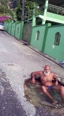Clever Trinidadian Man Turns A Pothole Into A Jacuzzi & Relaxes In The Middle Of The Road!
